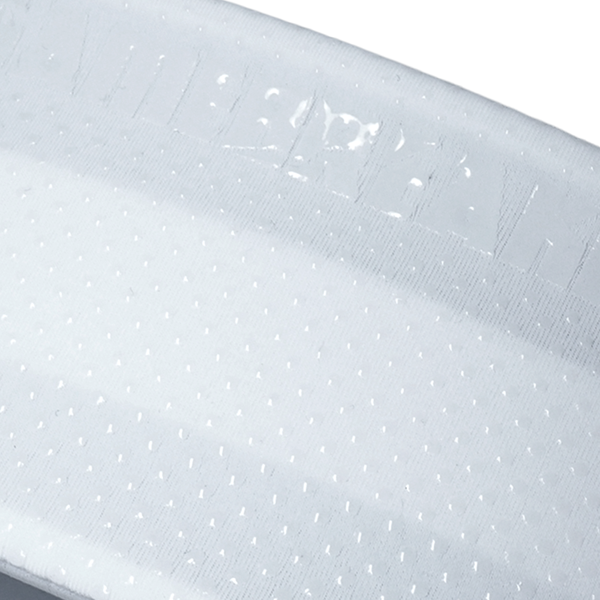 Close-up of a light gray textured fabric with a repeating small dot pattern and a stitched brand name near the top edge.