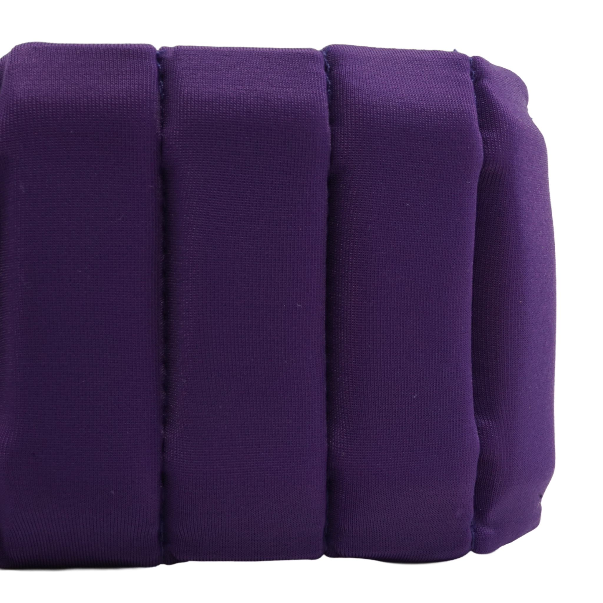 A close-up of a purple padded cushion with vertical channel stitching, shown against a plain white background.