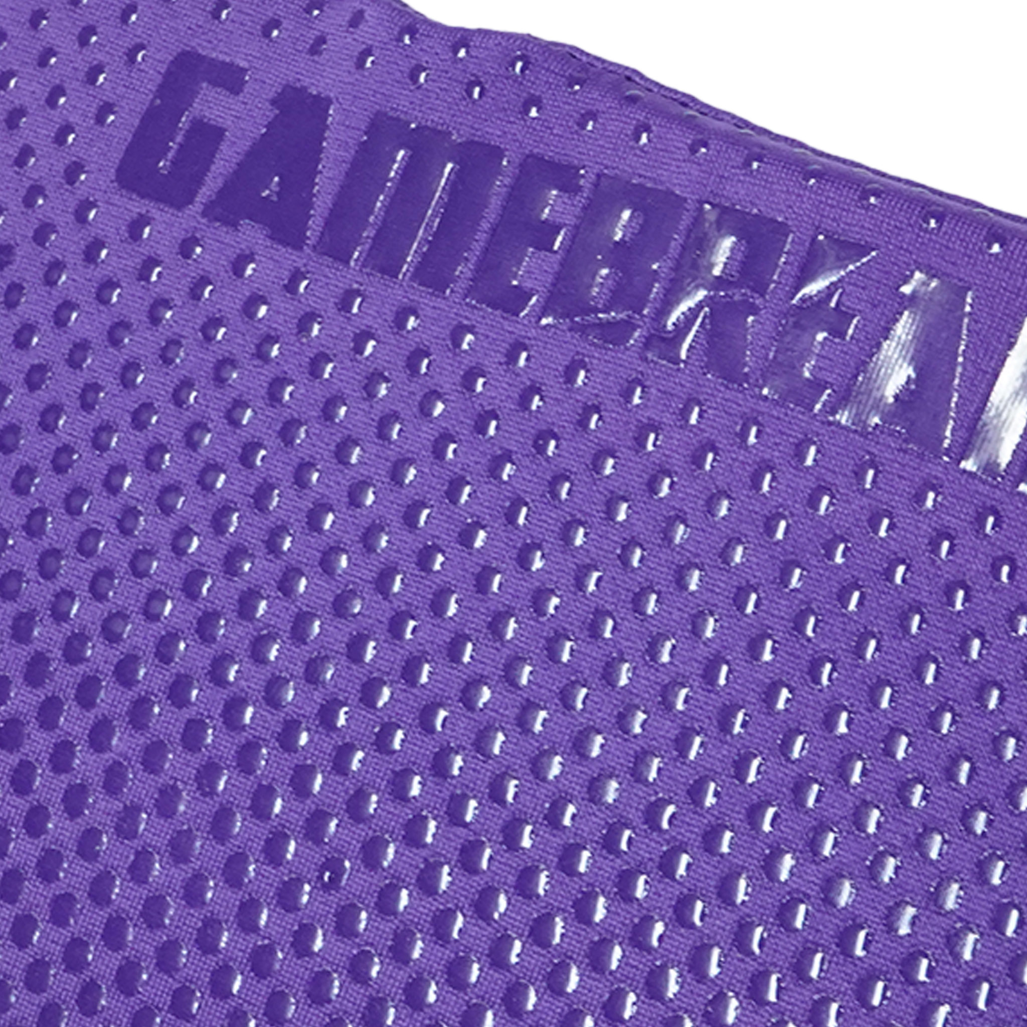 Close-up of a purple athletic mesh fabric with a raised embossed logo reading GAMEBREAKER.