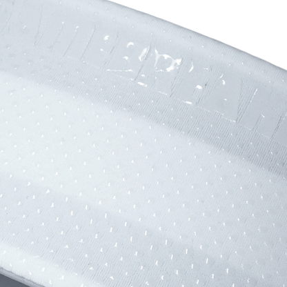 Close-up of a light gray textured fabric with a repeating small dot pattern and a stitched brand name near the top edge.