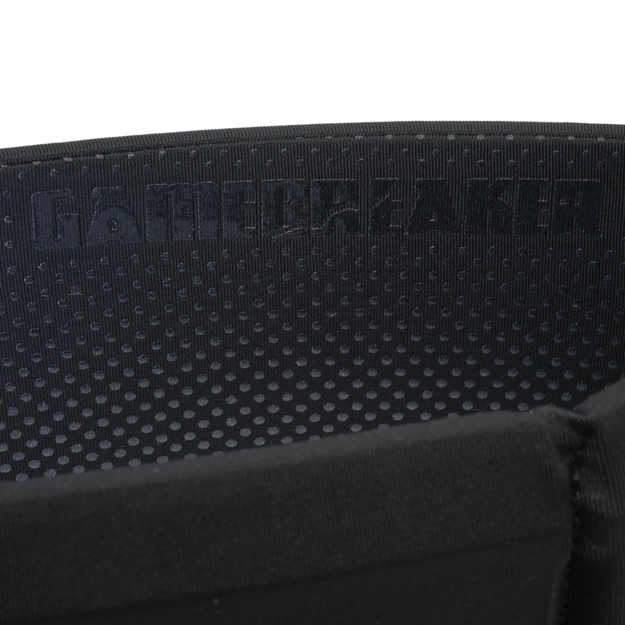 Close-up of a black textured fabric strap with a repeating circular pattern and the debossed brand name 'GAMEBREAKER' across the top, set against a plain white background.