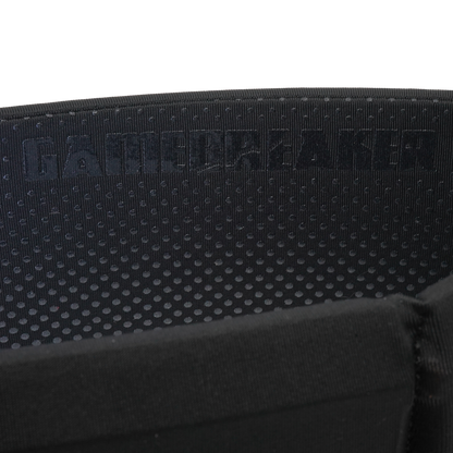 Close-up of a black textured fabric strap with a repeating circular pattern and the debossed brand name 'GAMEBREAKER' across the top, set against a plain white background.