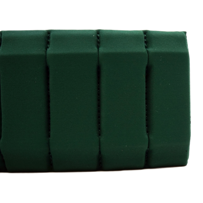 A close-up of a dark forest green fabric accessory, showing a textured surface with vertical stitched channels, on a plain white background.