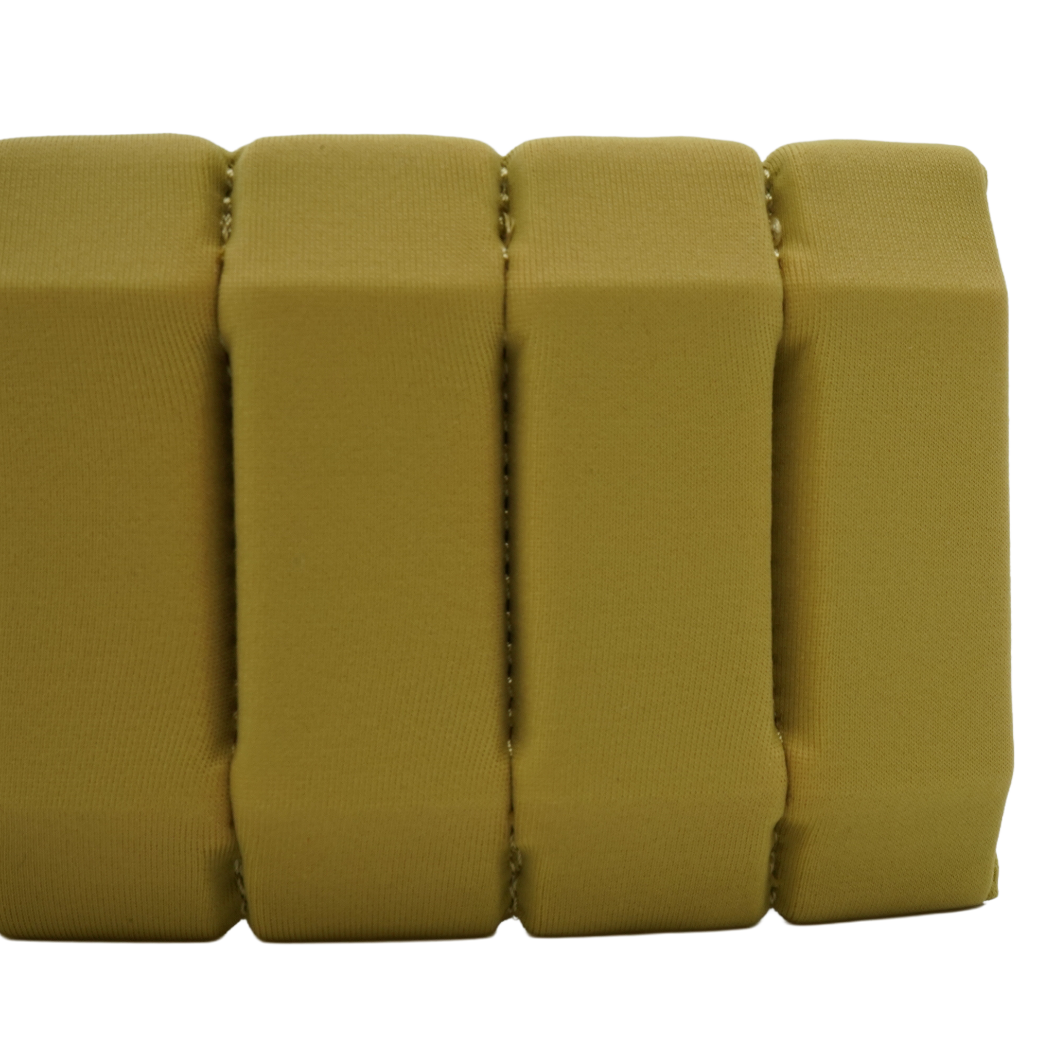 A close-up of a gold textured foam or cushioned strip with vertical ribbed sections, shown against a plain white background.
