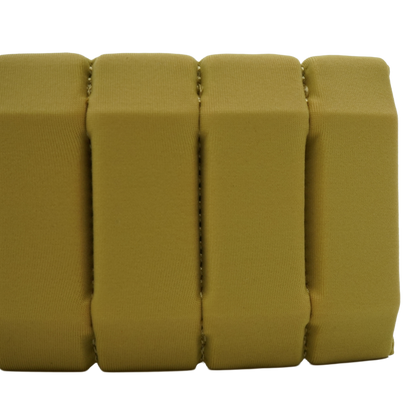 A close-up of a gold textured foam or cushioned strip with vertical ribbed sections, shown against a plain white background.