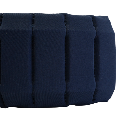 Close-up of a dark navy blue padded fabric strap or band with stitched vertical channels, shown against a plain white background.
