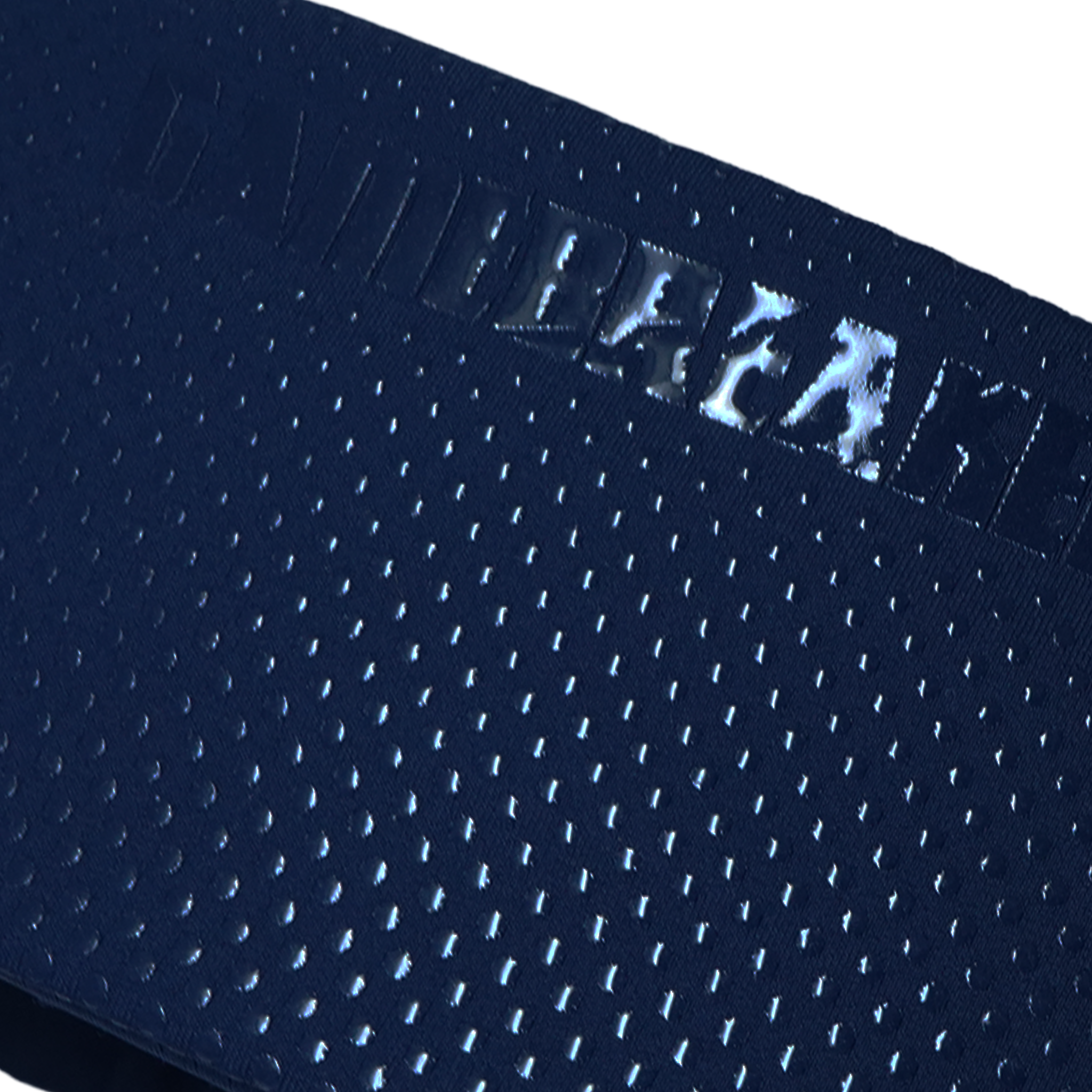 Close-up of a dark navy blue athletic mesh fabric with a repeating perforated pattern and a reflective metallic logo reading 'GAMEBREAKER' across the waistband.