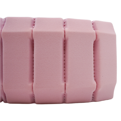 A close-up of a pink textured foam or cushioned strip with vertical ribbed sections, shown against a plain white background.