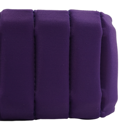 A close-up of a purple padded cushion with vertical channel stitching, shown against a plain white background.