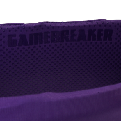 Close-up of a purple athletic headband with a perforated texture and the brand name 'GAMEBREAKER' printed in dark lettering.