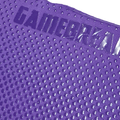 Close-up of a purple athletic mesh fabric with a raised embossed logo reading GAMEBREAKER.