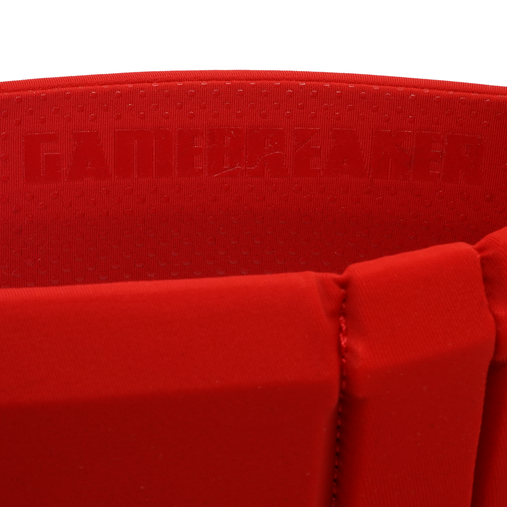 Close-up of a bright red athletic headband with a textured inner lining and embossed brand text reading GAMEBREAKER.