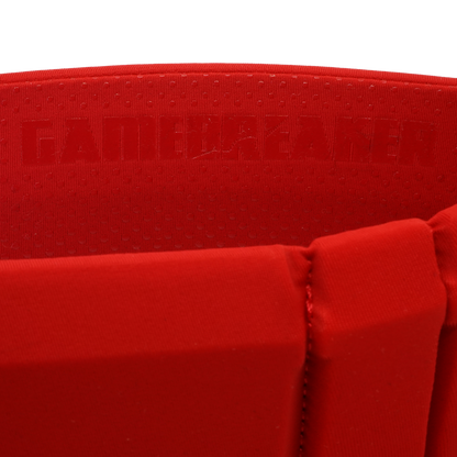 Close-up of a bright red athletic headband with a textured inner lining and embossed brand text reading GAMEBREAKER.
