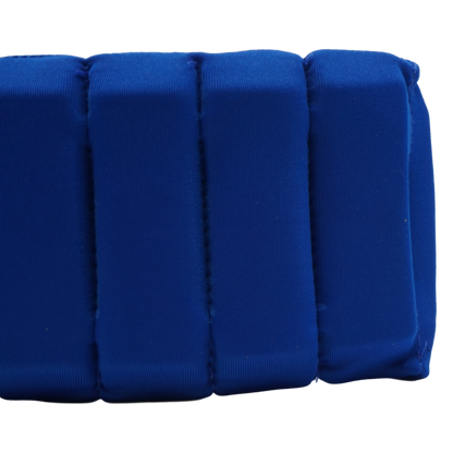 A close-up of a royal blue padded cushion with vertical channel stitching, shown against a plain white background.