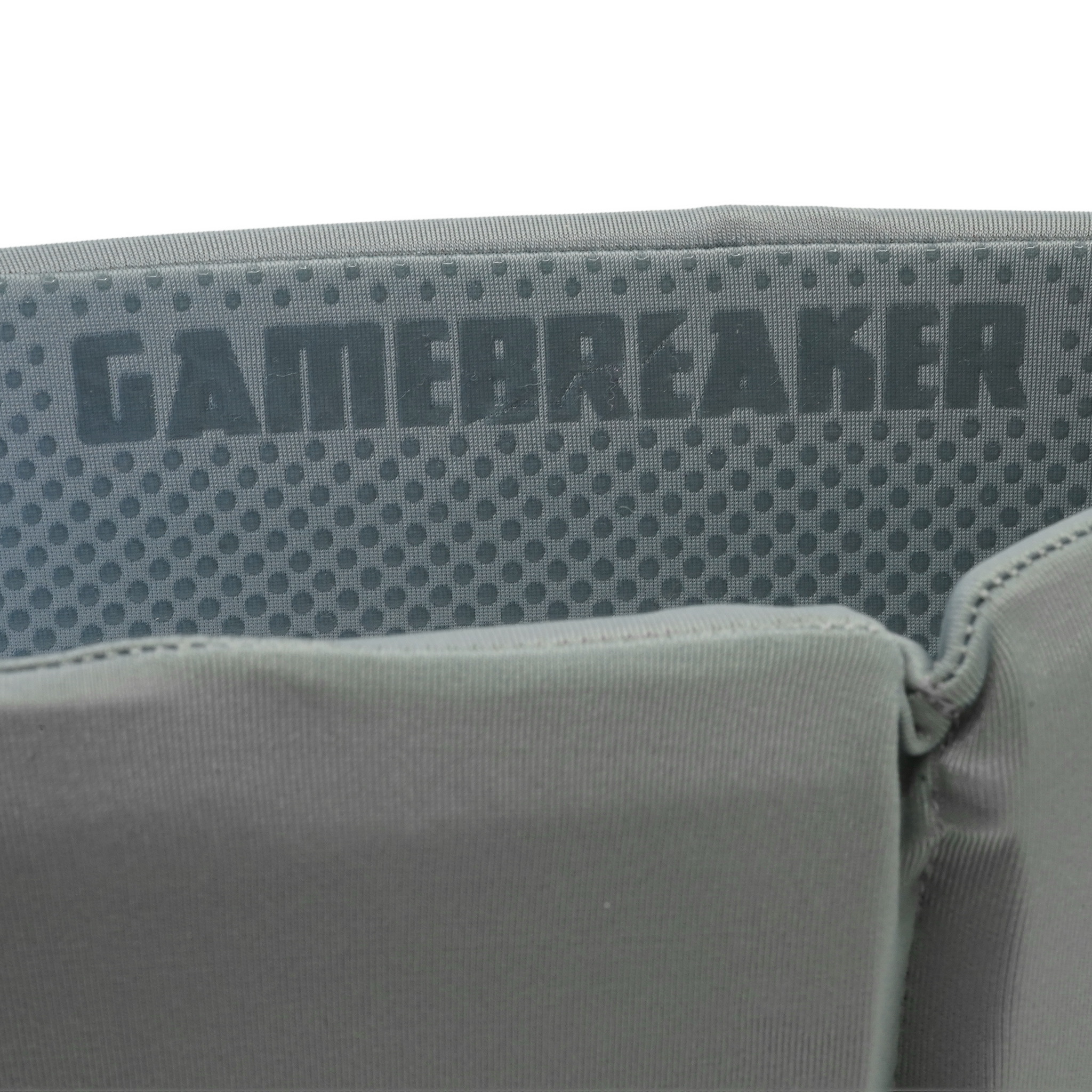 Close-up of a gray headband with a textured mesh panel and the word GAMEBREAKER printed across it.