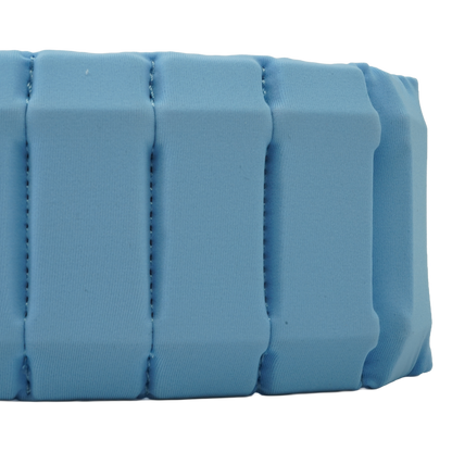 A close-up of a light blue padded fabric strap or band with stitched vertical channels, shown against a plain white background.