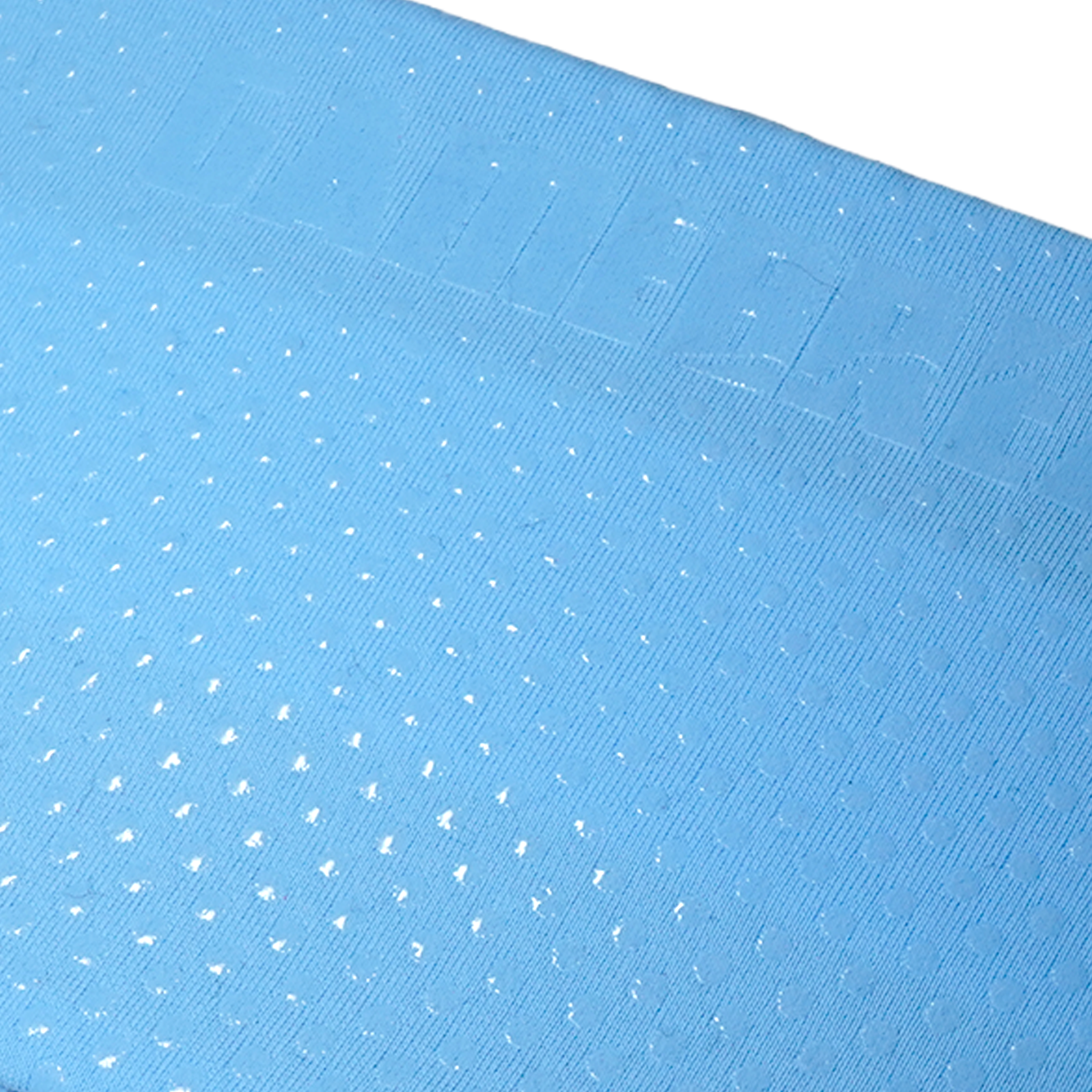 A close-up of a light blue textured fabric with a repeating pattern of small white embroidered dots and a stitched border along the top edge.